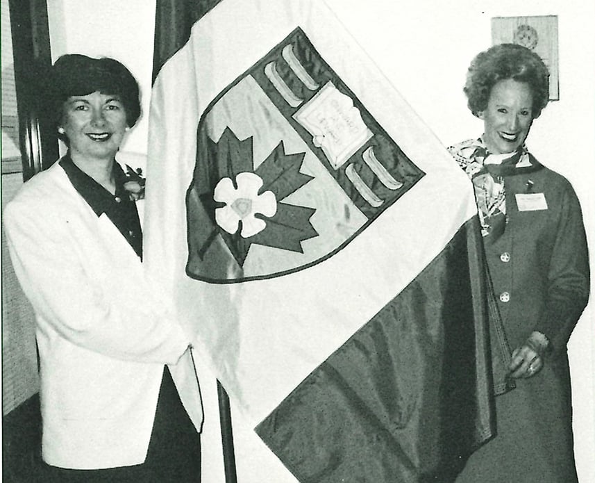 Nora (Mitchell) Newlands ‘67 and Pauline (Agnew) Hall ‘54 holding the new YHS Flag on April 28, 1993, after the proclamation of the YHS Coat of Arms and Heraldic Flag as part of the school’s 60th Anniversary